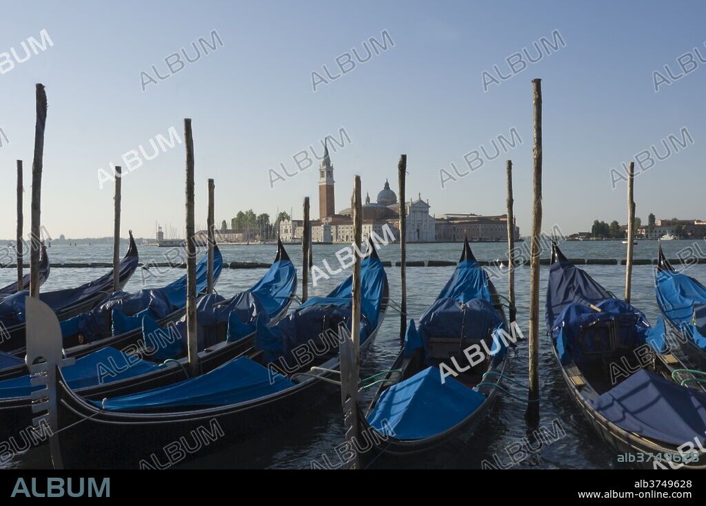 Moored gondolas and the island church of San Giorgio Maggiore, Venice, UNESCO World Heritage Site, Veneto, Italy, Europe.