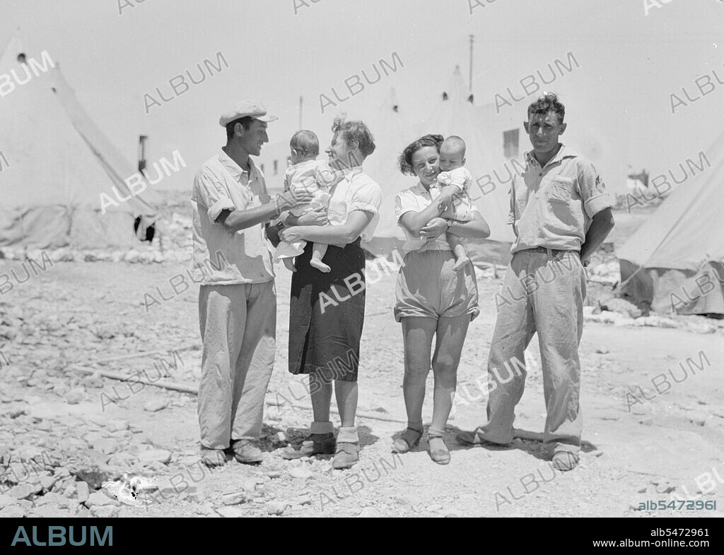 Maalek Hachamisha (Ma'ale HaHamisha) Kibbutz. Group of colonials, immigrants, holding babies ca. 1939.