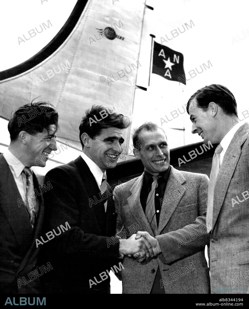 Australian professional cyclist, Sid Patterson, and Dutch cyclist, Jan Derksen (second and third from left) greeted by Essendon full-forward John Coleman (right) and Cyril Bardsley (left), an English rider, when they arrived in Melbourne today. December 29, 1952.