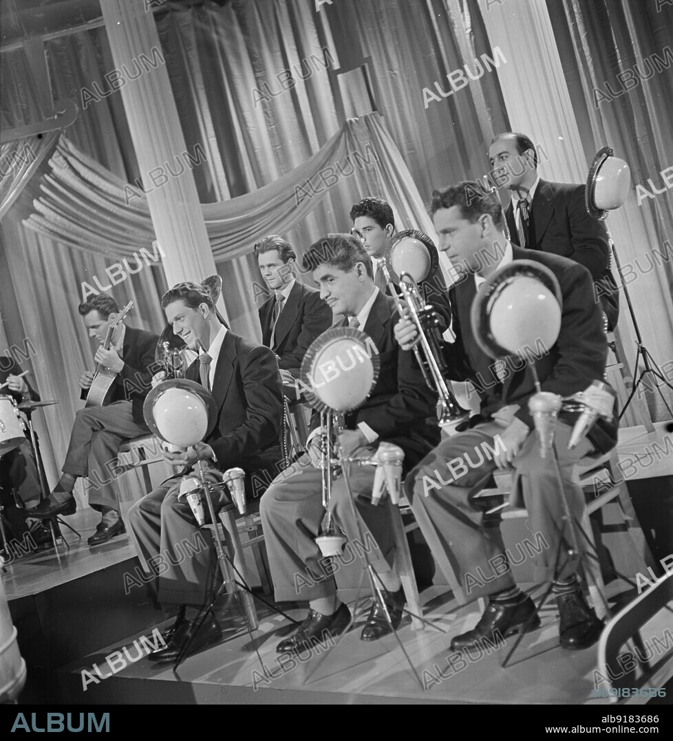 WILLIAM PAUL GOTTLIEB. Portrait of Emil Terry, Lou Mucci, Eddie Zandy, Barry Galbraith, Bill Barber, Al Langstaff, and Vahe (Tak) Takvorian, Columbia Pictures studio, the making of Beautiful Doll, New York, N.Y., ca. Sept. 1947.