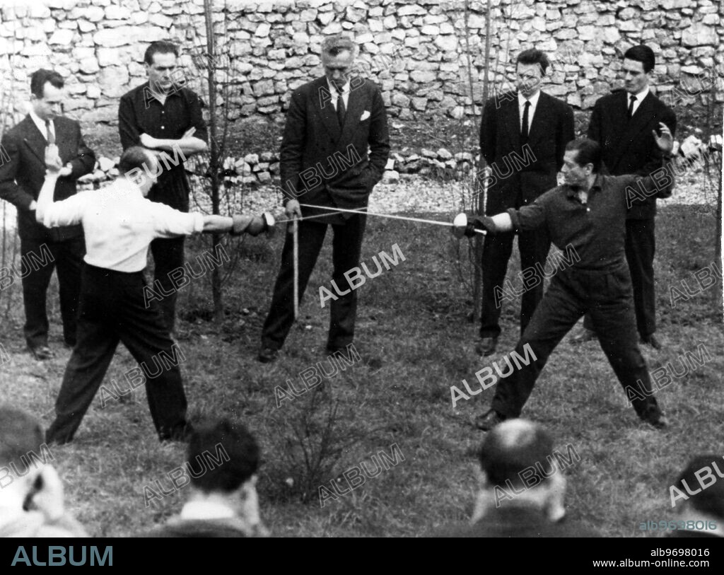 Moulin Du Val , Nr Vernon France. Famous Duel of Honour between ballet impressario Marquis Du Cuevas ( 72 ) and Ballet choreographer Serge Lifar ( 52 ) was settled when the two fought a duel . The Marquis beat his 20 year younger opponent by wounding him on right forearm thus drawing first blood after duel embraced and departed on friendly terms . 30 March 1958.