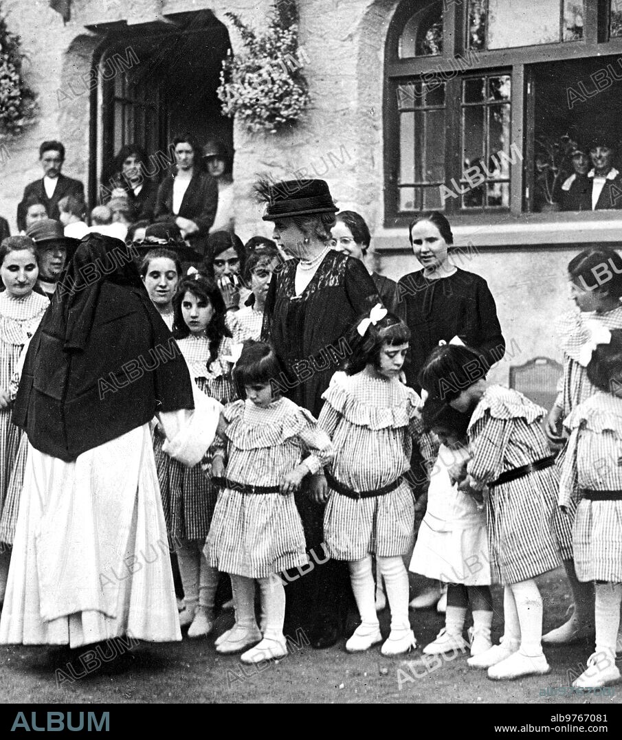 August 6, 1923. Saint Sebastian. In the San Rafael asylum. HM Queen María Cristina (X), Surrounded by Several Little Blind Girls, after attending the blessing of a new pavilion.