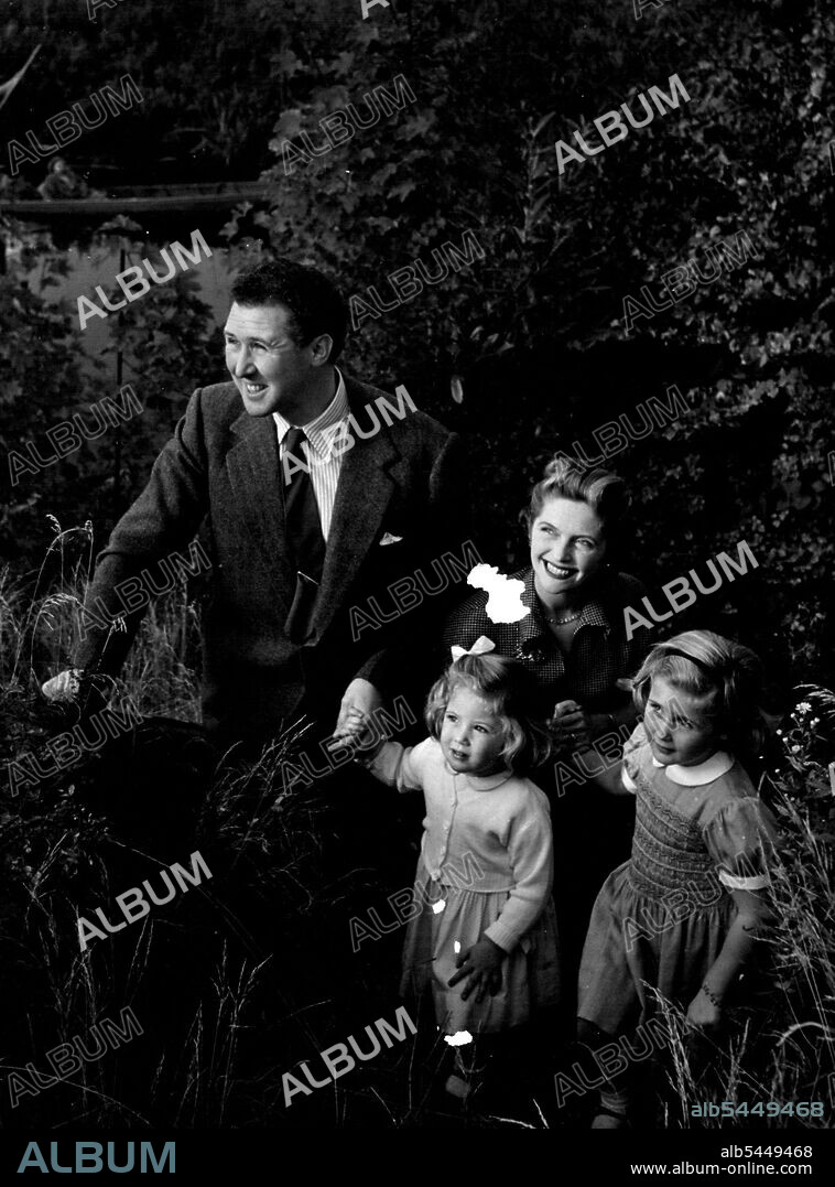 The Quayles At Home -- Anthony Quayle, actor, producer, and director of the Shakespeare Memorial Theatre, Stratford-upon-Avon, with his actress wife Dorothy (nee Hyson); and their daughters Jennifer (2½), and, right, Rosanna (4½). They are photographed in the grounds of their home at Stratford-on-Avon. May 1, 1953. (Photo by Tom Blau, Camera Press).