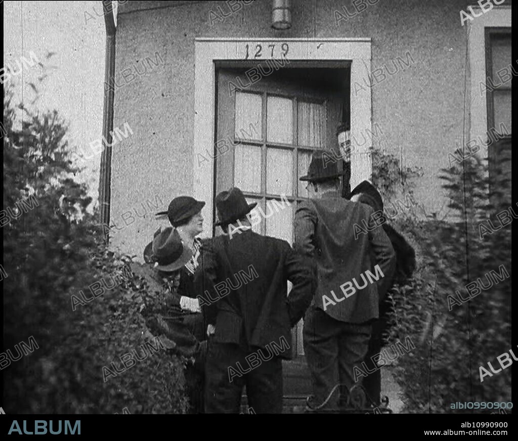American Civilians Outside Bruno Richard Hauptman's House in the Bronx, New York City, 1930s. "The crime of the century" - the Lindbergh kidnapping case, USA. '1279, East Two-Hundred-and-Twenty-Second Street, the Bronx in the state of New York. Here lived the suspect [Bruno Richard Hauptmann]'. From "Time To Remember -  The Tough Guys", 1930s  (Reel 3); documentary film, mainly about life in depression- and gangster-hit America.