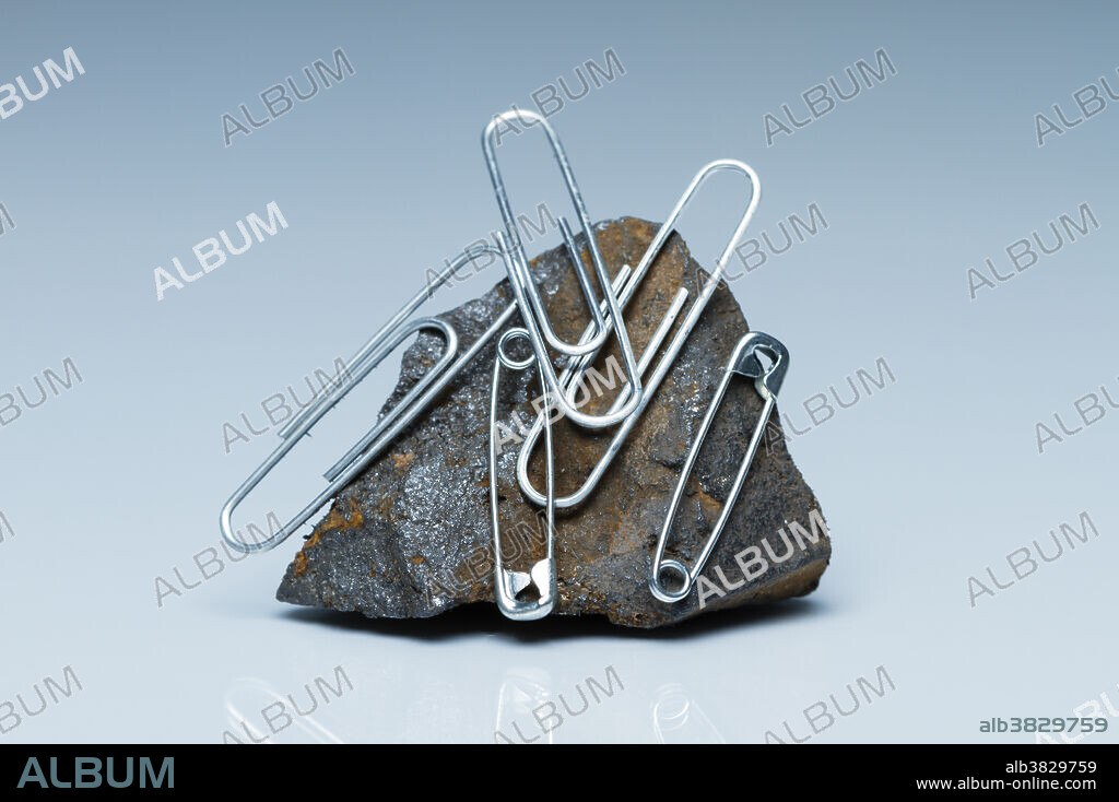 Magnetite. Magnetite is a mineral of iron oxide (Fe3O4, iron(II,III) oxide). It is a naturally-occurring ferromagnetic and can be magnetized to become a permanent magnet. Naturally-magnetized magnetite is called lodestone. Here a piece magnetite is shown to attract steel paper clips and safety pins.