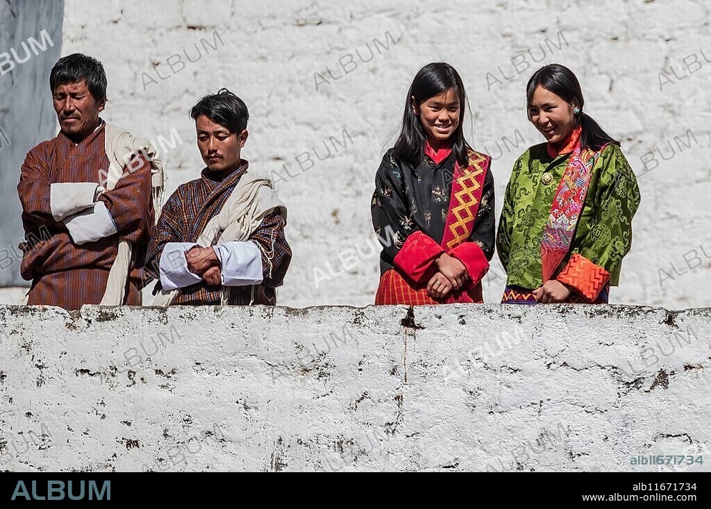 Bhutanese people in traditional clothes watching the annual Tsechu of Trongsa Dzong, Bhutan, Asia.