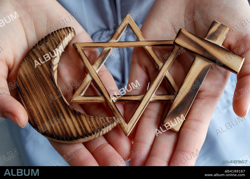 Christianity, Islam, Judaism 3 monotheistic religions. Jewish Star, Cross and Crescent : Interreligious symbols in hands.