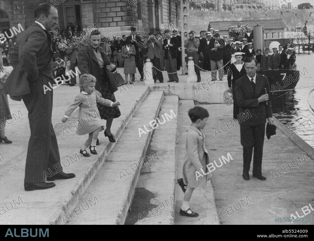 Down the steps to the quay side at Valletta, Malta, goes Prince Charles. And skipping after him, in wait-for-me style, follows Princess Anne. But although the golden-haired Anne went as fast as she could go, she could not keep up with Charles's longer legs. The children were returning to the Royal yacht Britannia after spending an afternoon ashore. With Princess Anne is her Artie Edwina - Lady Mountbatten. April 26, 1954. (Photo by Daily Mirror).