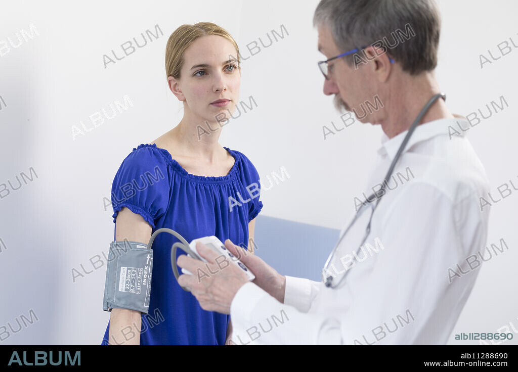 Taking a patient's blood pressure.