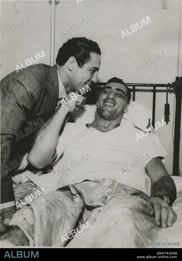 June 29, 1934. Max Baer visits Primo Carnera at Columbus Hospital in New York, where he is recovering from the broken ankle he suffered during the recent fight. Carnera explains to Baer how he would have wanted to touch him during the fight.