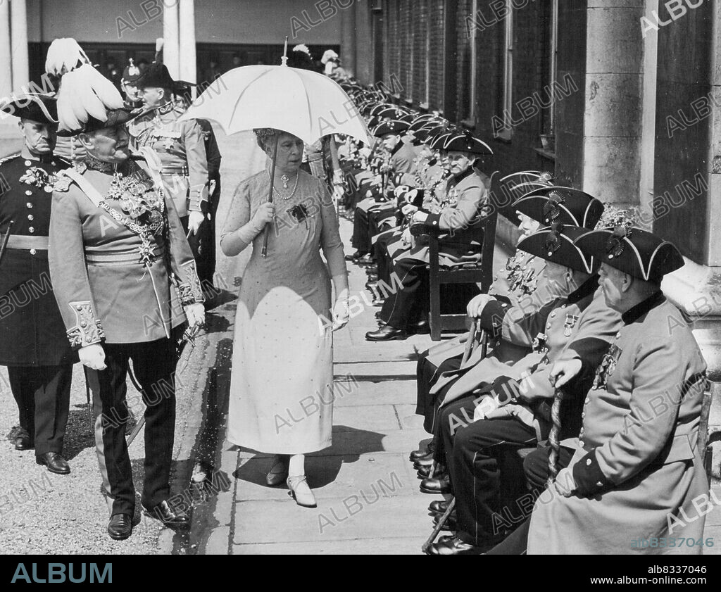 Queen Mary Inspects Chelsea Old Pensioners -- Queen Mary, Accompanied by Gen. Sir Walter Braithwaite, Govern of the Hospital, talking to veteran Chelsea Pensioners. Queen Mary paid an unexpected visit to Chelsea Royal Hospital this morning, and attended the " Oak Apple Day " parade, in commemoration of the foundation of the Hospital by King Charles II. May 29, 1937. (Photo by Keystone).
