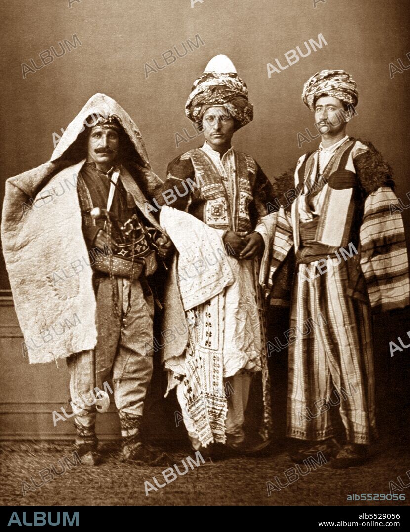 From 'Les Costumes Populaires De La Turquie' (1873). A collection of photographs by the famous photographer Pascal Sebah on the occasion of the universal exposition in Vienna in 1873. The album represents the costumes of the different regions, and ethnic and religious groups of the Ottoman Empire. On the right is a Kurd from Aljazeera (Iraq). Center, a Kurd of Mardin (Syria). On the left is a shepherd from the province of Diyarbakir (Turkey).