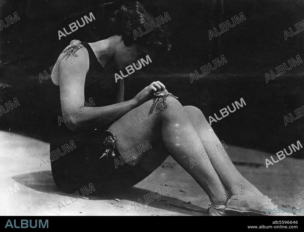 Voyage et loisirs : baignade en mer. Marjorie Beleau sur la plage de Long Beach (New York) s' occupant à dresser des crabes. V. 1920.