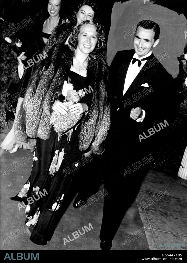 Premiere --- Life of Emile Zola -- Among those of the music world who attended the premiere of the Paul Muni triumph last night at the Carthay Cirole were Mr. & Mrs. Irving Berlin, who are pictured above as they walk down the walk which leads to the theatre. Mr. & Mrs. Irving Berlin seldom appear in public, and the occasion is rare indeed when Hollywood cameraman is able to obtain a picture of the two. February 22, 1938. (Photo by Hollywood Pictorial Photos).