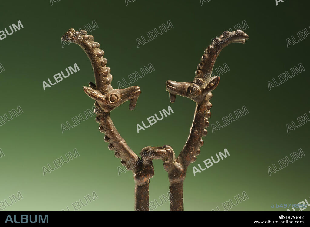 A bronze standard crown decorated with two opposed stylized ibexes, ceremonial object, metal, bronze, H 15 cm, W 7.8 cm, Iron Age II 1000-800 BC, Iran.