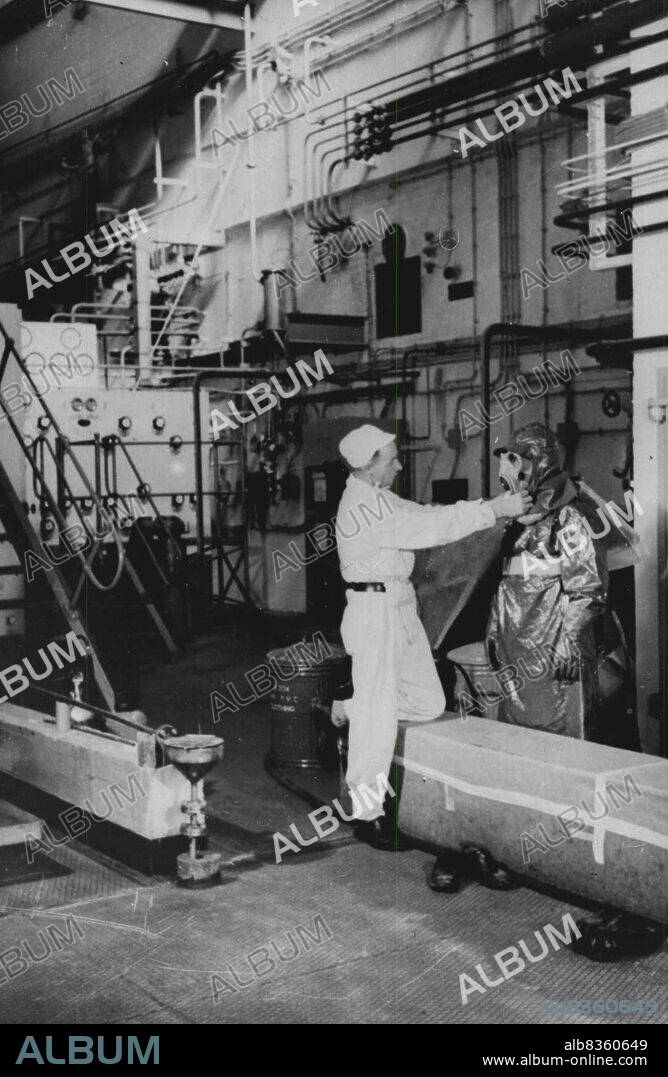 Inside Britain's Atomic Factories -- Many areas of the chemical plant at Windscale are highly active but brief visits can be made for maintenance purposes is protective clothing is worn.The respirator has its own air supply: the hood, overalls and gloves completely cover the body: stout rubber boots protect the feet.Britain now has atomic factories in action in three areas - Springfields, Windscale and Capenhurst. So rigid are the checks constantly made on the health and well-being of the workers that it is reckoned that it is far less dangerous working under these atomic conditions than in many other industries. March 19, 1954. (Photo by Sport & General Press Agency, Limited).