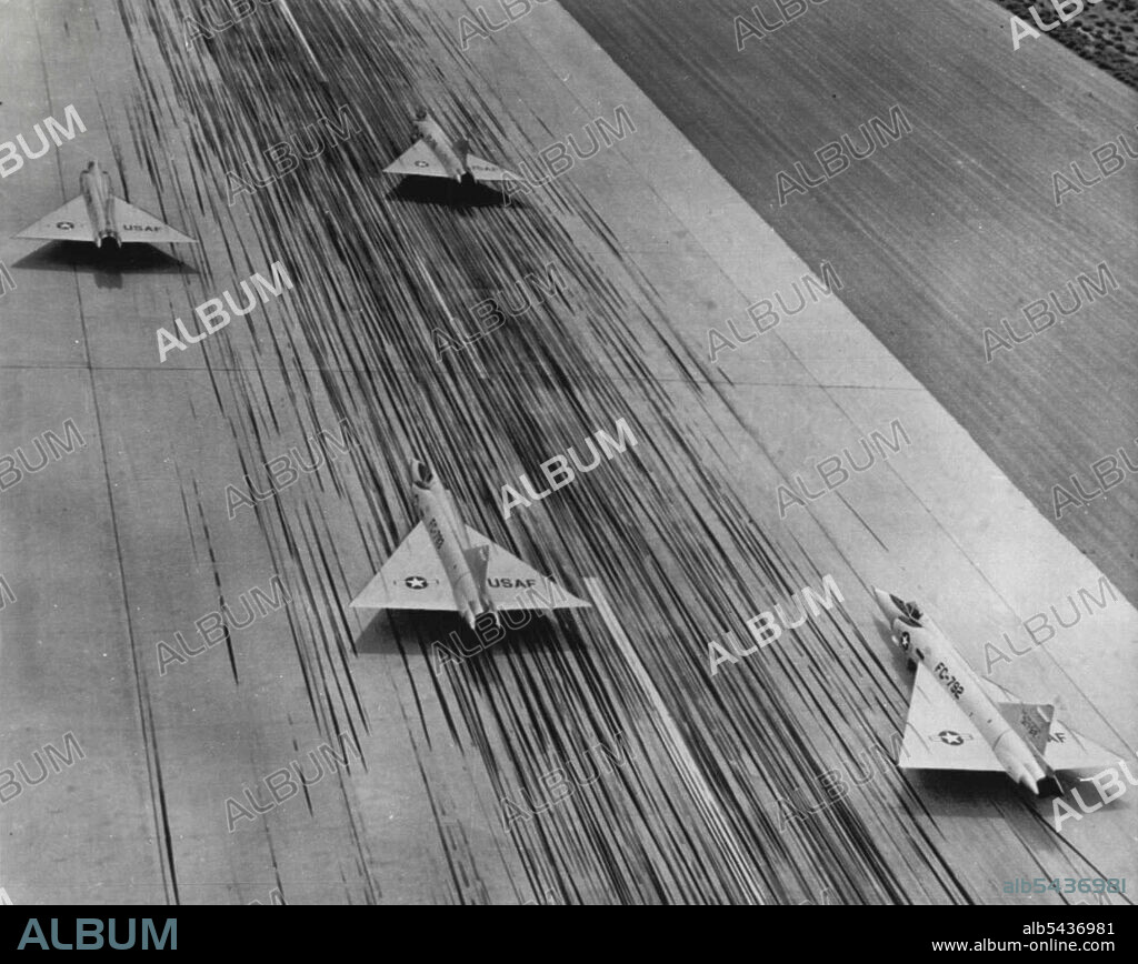 Illusion of Speed - These four Convair F-102A all-weather jet interceptors seem to be racing down runway at Palmdale, Calif. The planes are standing still but the illusion of speed comes from the delta wing interceptors streamlining and from the hundreds of tire streaks left on the concrete runway by landing aircraft. October 04, 1955. (Photo by AP Wirephoto).