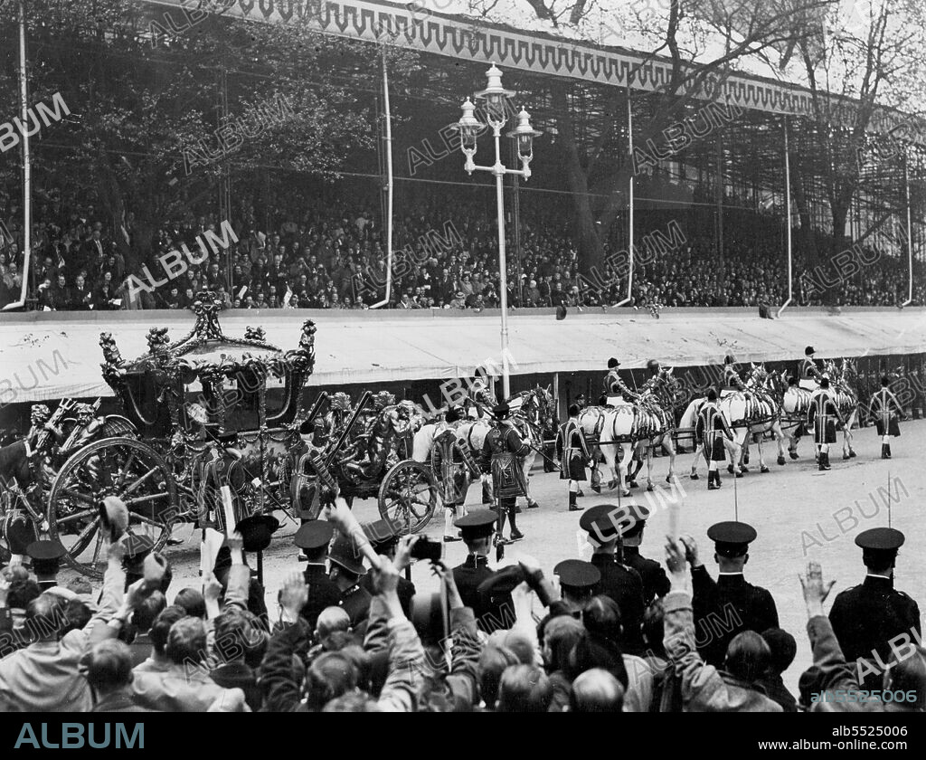 The Coronation of King George VI And Queen Elizabeth -- A view of the Coronation Coach, containing their Majesties, arriving at Westminster Abbey, The Queen is clearly seen bowing to the people lining the route. May 12, 1937. (Photo by Photographic  News Agencies Ltd.).