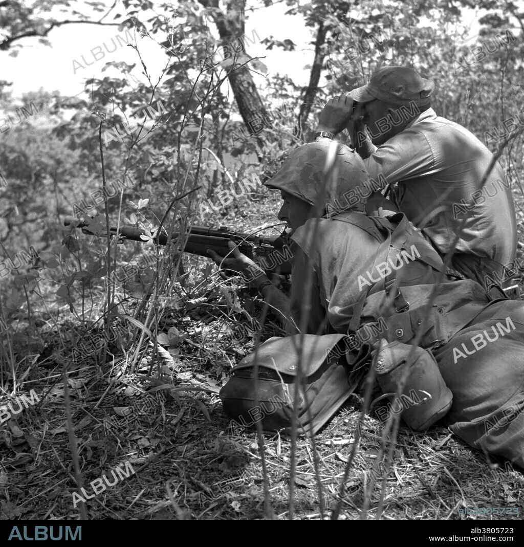 Caption: "A Marine sniper and spotter of the 1st Marine Division work together in picking off the enemy in Korea." A sniper is a highly trained marksman who operates alone, in a pair, or with a sniper team to maintain close visual contact with the enemy and engage targets from concealed positions or distances exceeding the detection capabilities of enemy personnel. These sniper teams operate independently, with little combat asset support from their parent units. Snipers typically have highly selective and specialized training and use high-precision/special application rifles and optics, and often have sophisticated communication assets to feed valuable combat information back to their units. Military snipers are trained in camouflage, field craft, infiltration, special reconnaissance and observation, surveillance and target acquisition.
