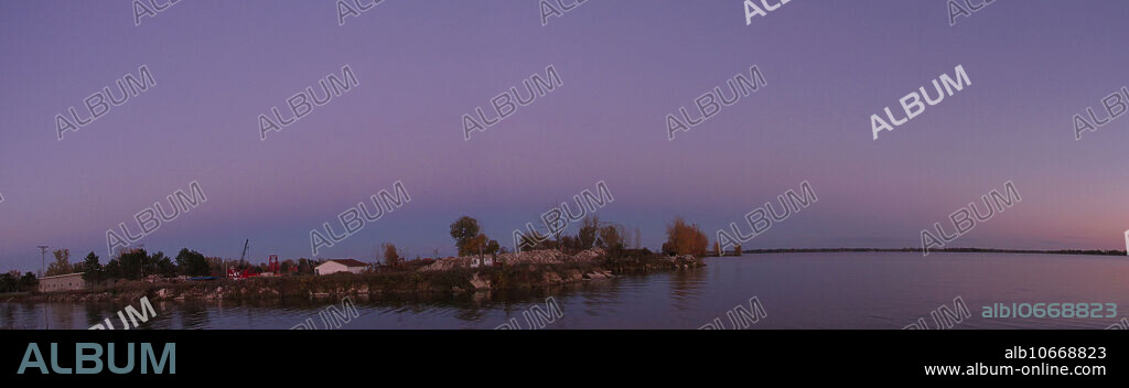 Panoramic view of The Belt of Venus, a Victorian-era name for an atmospheric phenomenon seen at sunrise and sunset. Shortly after sunset or shortly before sunrise, the observer is, or is very nearly, surrounded by a pinkish glow (or anti-twilight arch) that extends roughly 10 to 20 degrees above the horizon. Often, the glow is separated from the horizon by a dark layer, the Earth's shadow or dark segment. The Arch's light rose (pink) colour is due to backscattering of reddened light from the rising or setting Sun.