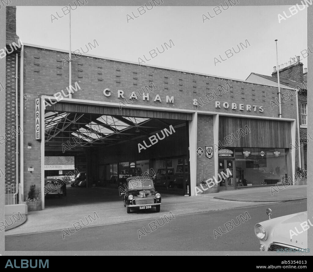 JOHN LAING PLC. A view of a Morris Minor driving out of the Graham & Roberts Garage. This image was catalogued as part of the Breaking New Ground Project in partnership with the John Laing Charitable Trust in 2019-20.
