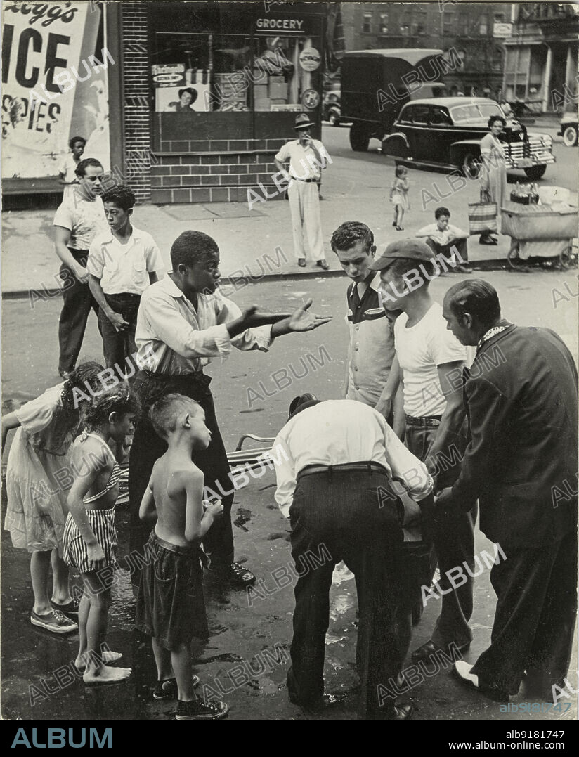 ROMULO LACHATANERE. Eastside - Group of men and youths gathered around an accident victim; one young man appears to be arguing with the others, East Harlem, New York City, 1947 - 1951.