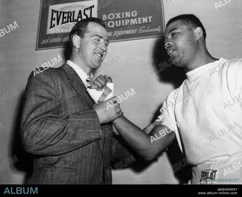 Orig. bildtext... THE BIG SWEDE FEELS THE CHAMP'S MUSCLE New York. Olle Tandberg, Swedish heavyweight fighter is pictured as he feels the steel-like muscle of Joe Louis' arm. Joe will fight Joe Walcott tomorrow night in Madison Square Garden with the title of Wolrd's Champion at stake. Tandberg will fight a few heavyweight fights against other American heavyweight contenders hoping to eliminate them all and get a crack at Louis' title. 12-4 47 Anm. O Tandberg, 1918-1996, svensk boxare. J Louis, eg Joseph Louis Barrow, 1914-1981, amerikansk boxare. Everlast Boxare Boxing equipment Hålla Idrottsmän Knytnävar Kollegor Känna Skyltar CD571 persons: OLLE TANDBERG;JOE LOUIS sites: SVERIGE*;NEW YORK;USA.