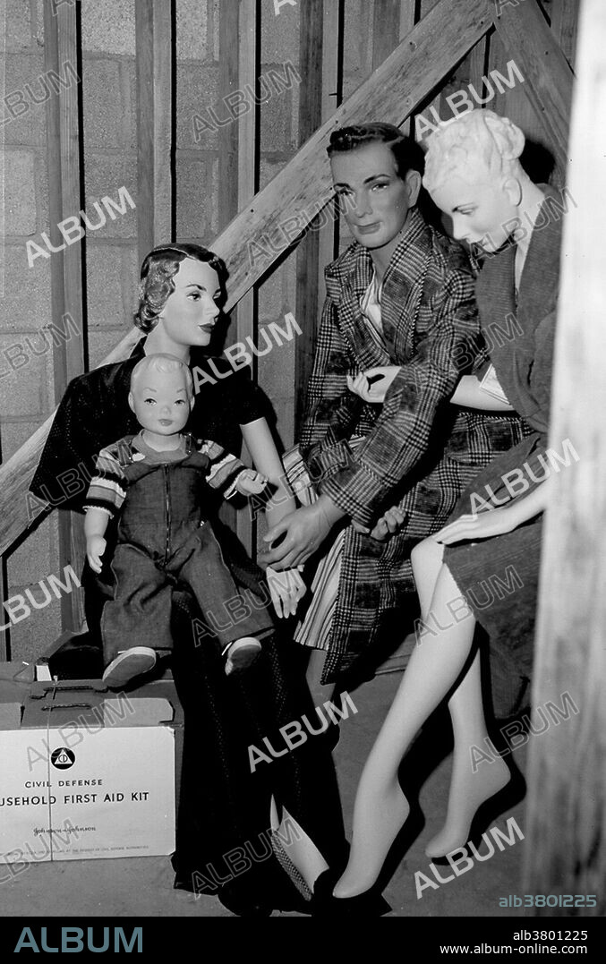Basement shelter with mannequins. Operation Doorstep was a civil defense study conducted by the Federal Civil Defense Administration in conjunction with Upshot-Knothole Annie. It studied the effect of the nuclear blast on two wooden frame houses, fifty automobiles and eight bomb shelters designed for residential use. The homes in the study were constructed in such a way as to minimize the thermal effects of Annie, with an eye towards determining if, in the absence of fire, the basement of the closer home (3,500 feet from the hypocenter) might shelter its occupants, while the second (at 7,500 feet) could remain standing. Both homes performed as expected under the conditions of their construction. Upshot-Knothole Annie was a nuclear weapons test conducted by the United States as part of Operation Upshot-Knothole. It took place at the Nevada Test Site on March 17, 1953, and was nationally televised. The live TV coverage was captured at the studio, presumably using at-the-time new magnetic tape sound technology, so it is a rare record of the sound an actual atomic bomb makes.