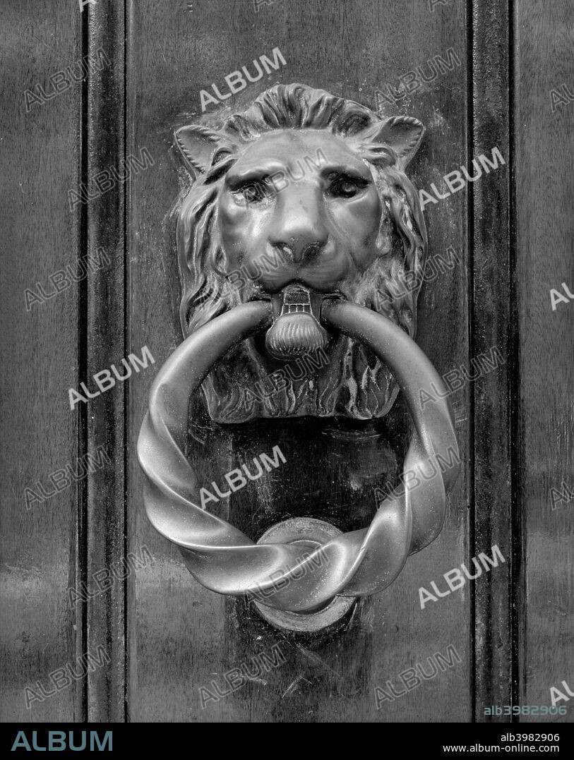 Door knocker in the form of a lion's head holding a ring in its mouth, at Selwyn House, Cleveland Row, Westminster, London, 1979.