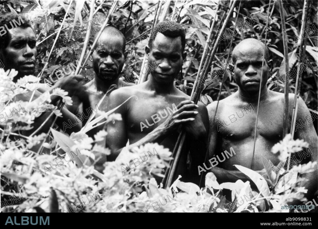 Asmat tribe West Irian. Asmat is probably the most well known tribe in Papua (formerly called Irian Jaya). They become famous not only through their head-hunting practices in the past, but also because of their unique ideas and wonderful designs in woodcarving.. The name most probably comes from the Asmat words As Akat, which according to Asmat people means "the right man". Moreover, it's also said that Asmat comes from the word Osamat that means "man from tree". The Asmat's neighbors to the west, the Mimika, however, claim the name is derived from their word for the tribe- "manue", meaning "man eater".