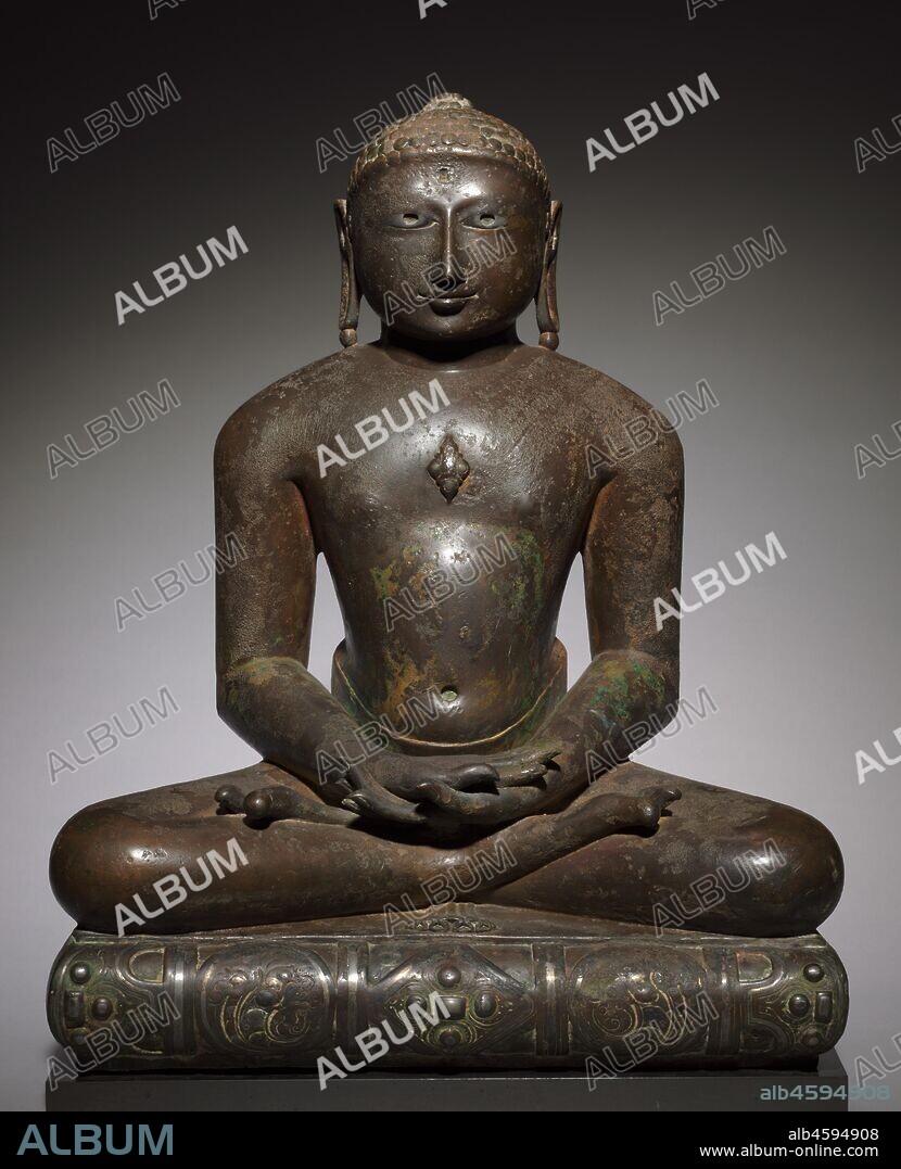 Jina (Tirthankara), 900s-1000s. Jainism was one of the three major religions to evolve in India, the other two being Hinduism and Buddhism. While each religion developed its own particular characteristics, their beliefs maintained a common ground with Hinduism. In both Jainism and Buddhism, deities symbolize enlightened beings whose example is meant to inspire believers in following the path toward salvation rather than worshipping them. In Jainism the most common deities are Jinas (meaning "liberators" or "victors"), also known as Tirthankaras ("holy men"). As the name implies, they are beings "liberated" through enlightenment from the cycle of rebirth. There are 24 of these Jain patriarchs.  This sculpture represents one of the 24 Jinas, but the absence of attributes makes it impossible to determine which one. This is not surprising since Jinas tend to look alike. Although this figure wears a cloth around his waist, Jinas are usually shown naked-a reference to their renunciation of worldly goods-and seated cross-legged in the posture of meditation (dhyanasana) with their hands resting in their laps (in the dhyana mudra), palms turned upward. Their physical appearance is always the same: broad shoulders, tapering torso, and long, highly stylized limbs. The head, with its round face and short-cropped curls, has a small protrusion at the top. The facial expression conveys self-assurance, wisdom, and compassion. Such a figure would usually have a halo attached to the back of the head. The present bronze dates to a time when some of the finest Jain sculptures and monuments were produced in India, as documented by such temples as Mt. Abu in Rajasthan (the area where this sculpture originated), Khajuraho in Madhya Pradesh, or Srivana Belgola in Karnataka.