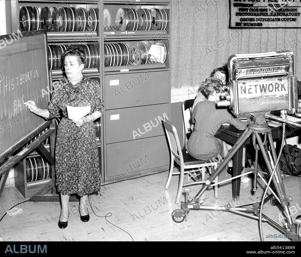 Filming of Ida Rhodes (left) at IBM. Rhodes demonstrates her pioneering work in computer translation of languages. Ida Rhodes (May 15, 1900 - February 1, 1986) was an American mathematician. Rhodes was a pioneer in the analysis of systems of programming, and with Betty Holberton designed the C-10 programming language in the early 1950s for the UNIVAC I. She also designed the original computer used for the Social Security Administration. Though she retired in 1964, Rhodes continued to consult for the Applied Mathematics Division of the National Bureau of Standards until 1971. Her work became much more widely known after her retirement, as she took the occasion to travel around the globe, lecturing and maintaining international correspondence. No photographer credited, November 16, 1960.