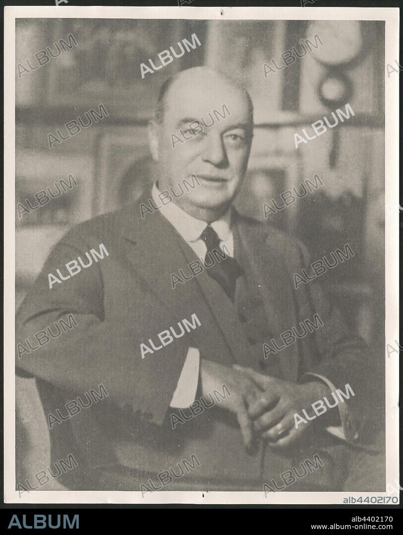 Photograph, Portrait of John Joseph Rouse, circa 1925-1935, Black and white photographic portrait featuring Kodak Australasia Pty Ltd managing director John Joseph (J.J.) Rouse circa 1925-1935. It appears to have been taken in his study, with family portraits displayed behind him. manufactured and distributed a wide range of photographic products to Australasia, such as film, paper, chemicals, cameras and miscellaneous equipment. Its client base.