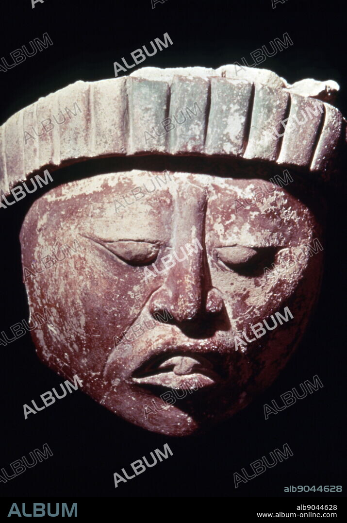 Mayan stucco head, 400-700 AD; Jaina Island. Jaina Island is a pre-Columbian Maya archaeological site in the present-day Mexican state of Campeche. A small limestone island on the Yucatan Peninsula's Gulf coast. The Island served as an elite Maya burial site, and is notable for the high number of fine ceramic figurines excavated there.
