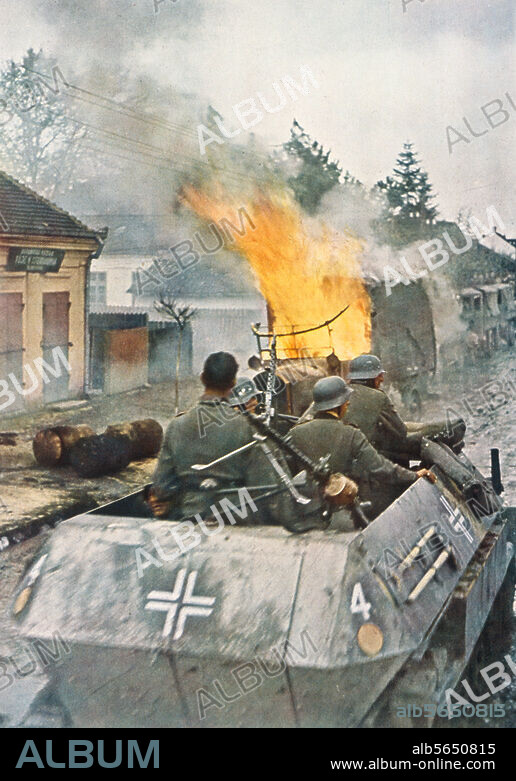 Geschichte / 2. Weltkrieg / Ostfront:. "Auf einer Vormarschstraße im Osten haben deutsche Panzer einen feindlichen Lastkraftwagen in Brand geschossen.". (Die 7. Panzerdivision - von den französischen Soldaten erhielt sie den Namen "Gespensterdivision" (La division fantome) - passiert die serbische Stadt Nis auf dem Vormarsch nach Belgrad). PK-Foto, koloriert, Zeitraum des Vormarsches 6. bis 17. April 1941, von Arthur Grimm (1908- nach 1990). Aus: Zeitschrift "die neue linie", August 1941, S.8.