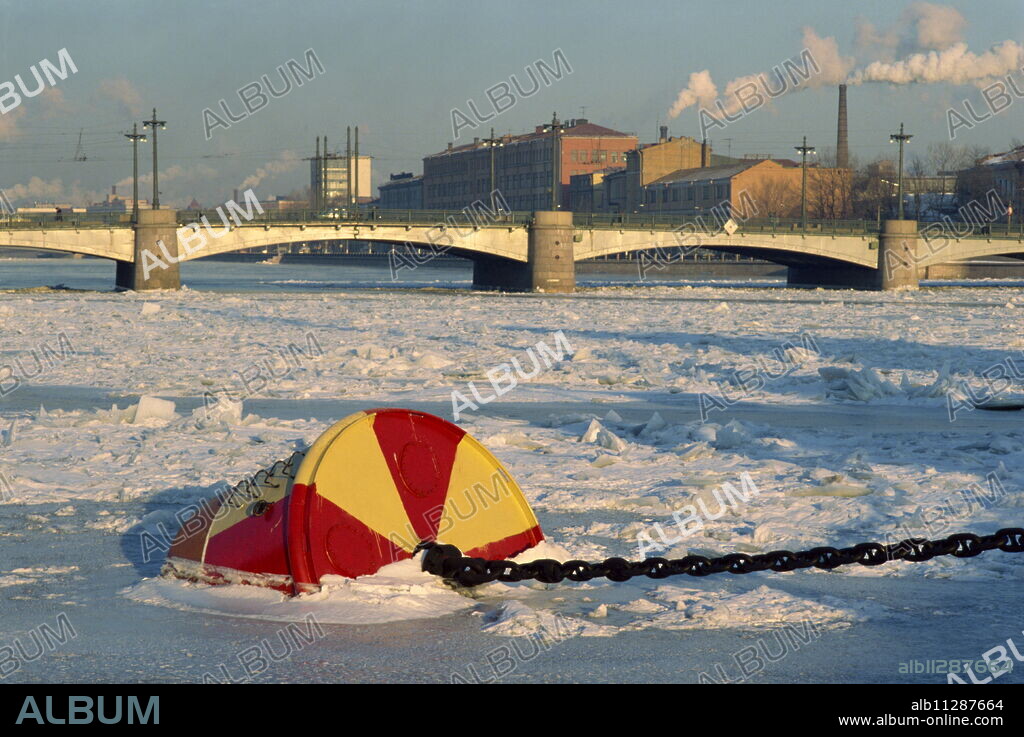 Buoy frozen into ice on the Bol'Shaya Nevka River, a tributary of the Neva, near the Svobody Bridge, St. Petersburg, Russia, Europe.