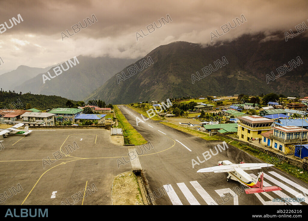 Plane about to take off between mountains, Lukla Airport, Sagarmatha National Park, Nepal, Asia.