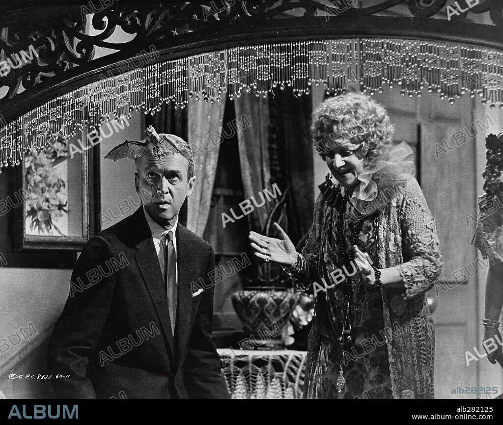 HERMIONE GINGOLD and JAMES STEWART in BELL BOOK AND CANDLE, 1958, directed by RICHARD QUINE. Copyright COLUMBIA PICTURES.
