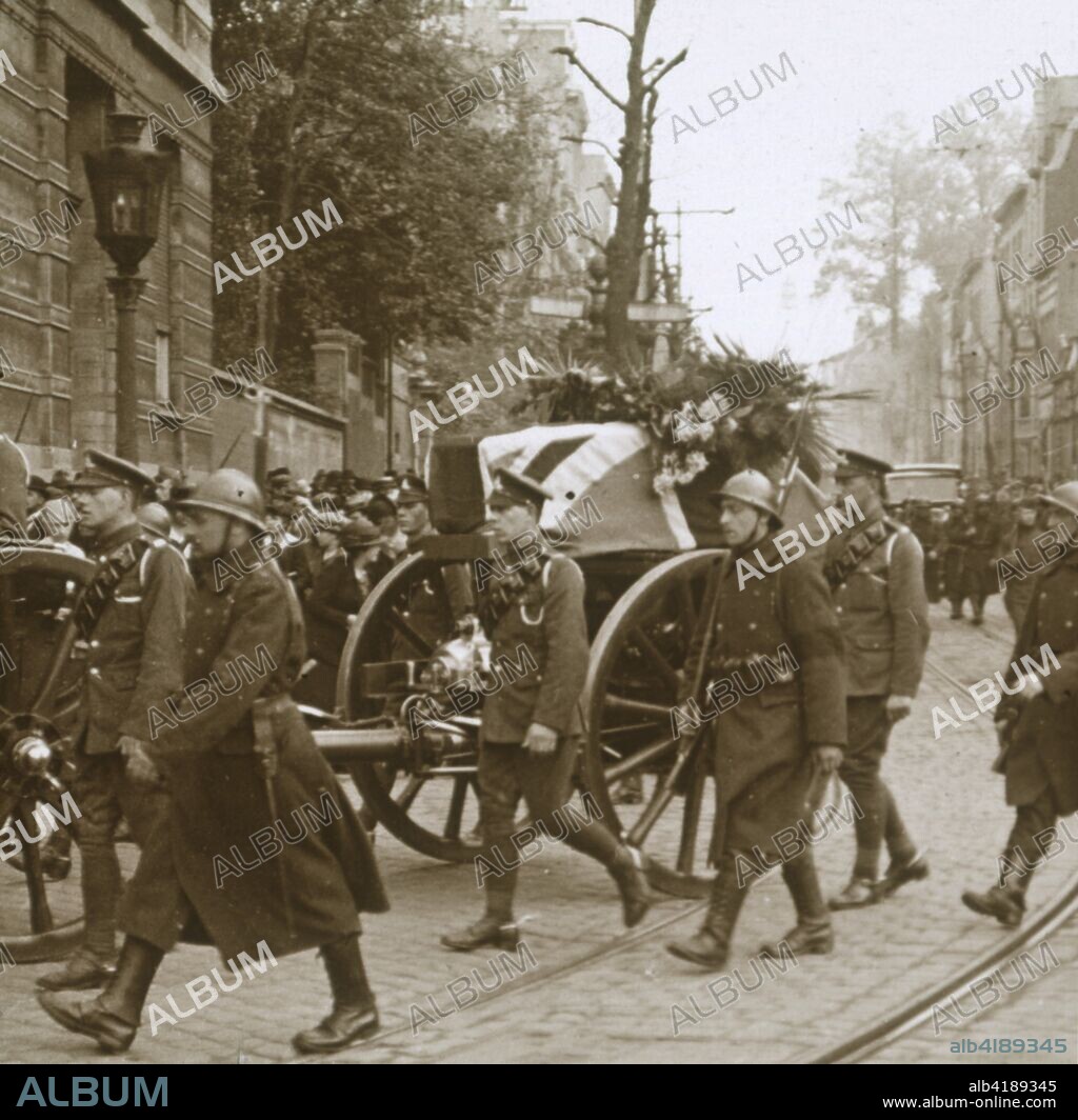 Burial of Edith Cavell, Brussels, Belgium, 1915. British nurse Edith Cavell (1865-1915) was appointed matron of the Berkendael Medical Institute, Brussels, in 1907. During the German occupation of Belgium in World War I, the Berkendael Institute was converted to a military hospital. In August 1915 Cavell was arrested by the Germans and tried and found guilty of assisting the escape of 200 Allied soldiers to neutral Holland. She was executed by a firing squad on October 12, 1915. She was buried in Brussels until after the war when her body was brought back to Britain for a memorial service at Westminster Abbey and then transferred to Norwich for re-burial. Photograph from a series of glass plate stereoview images depicting scenes from World War I (1914-1918).