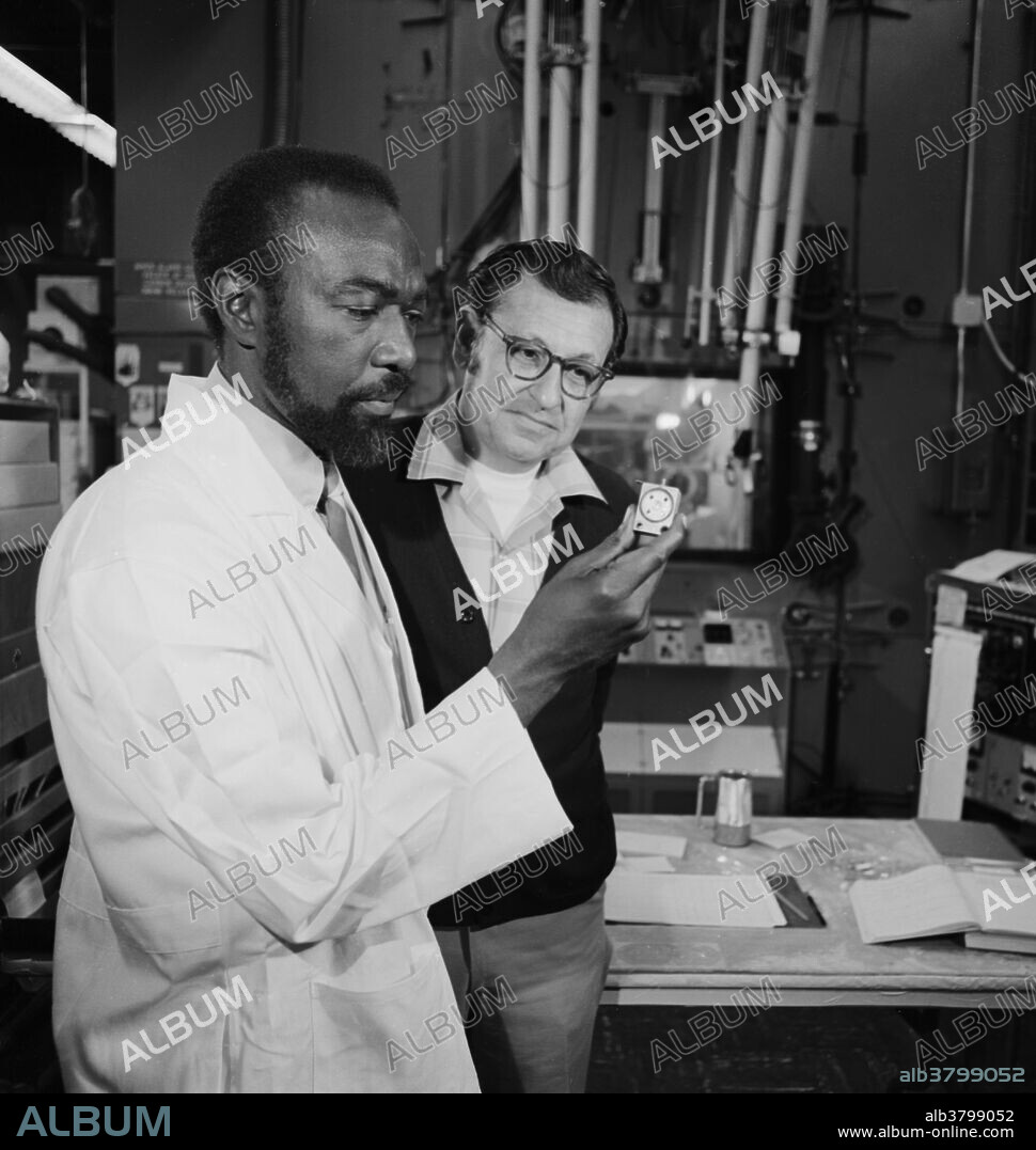 Jim Harris (left) and Albert Ghiorso with element 105 target, April 21, 1970. Albert Ghiorso (July 15, 1915 - December 26, 2010) was an American nuclear chemist. In the early 1940s, Glenn Seaborg moved to Chicago to work on the Manhattan Project. He invited Ghiorso to join him, and for the next four years Ghiorso developed sensitive instruments for detecting the radiation associated with nuclear decay, including spontaneous fission. After the war, Seaborg and Ghiorso returned to Berkeley, where they and colleagues used the 60" Crocker cyclotron to produce elements of increasing atomic number by bombarding exotic targets with helium ions. Ghiorso invented numerous techniques and machines for isolating and identifying heavy elements atom-by-atom. He died in 2010 at the age of 95. James Andrew Harris (March 26, 1932 - December 12, 2000) was the first African-American to participate in a major new-element identification program. He was codiscoverer with Ghiorso of rutherfordium (element 104) and dubnium (element 105). He extended his scientific training with graduate courses in chemistry and physics and received an honorary doctorate from Houston-Tillotson College for his contributions to the discovery of new elements. He devoted much of his free time to recruiting and supporting young African American scientists and engineers, often visiting universities in other states.