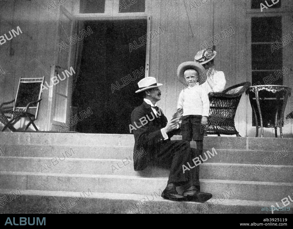 King Haakon VII of Norway (1872-1957), his son Olav (1903-1991), the future King Olav V, and Princess Victoria (1868-1935) at Bygdøy, Norway, 1908. From Queen Alexandra's Christmas Gift Book, Photographs from My Camera, by Queen Alexandra, published by The Daily Telegraph (London, 1908).