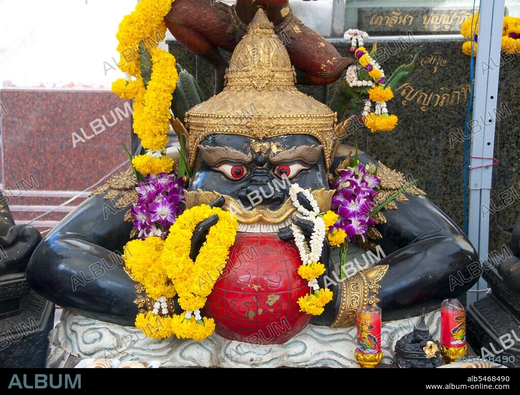 In Hindu mythology, Rahu is a snake that swallows the sun or the moon causing eclipses. He is depicted in art as a dragon with no body riding a chariot drawn by eight black horses. Rahu is one of the navagrahas (nine planets) in Vedic astrology. The Rahu kala (time of day under the influence of Rahu) is considered inauspicious. According to legend, during the Samudra manthan, the asura Rahu drank some of the divine nectar. But before the nectar could pass his throat, Mohini (the female avatar of Vishnu) cut off his head. The head, however, remained immortal. It is believed that this immortal head occasionally swallows the sun or the moon, causing eclipses. Then, the sun or moon passes through the opening at the neck, ending the eclipse. Wat Traimit is a Thai Buddhist temple found in the Chinatown area of Bangkok. It is chiefly known for housing the world's largest solid gold Buddha figure, the Phra Phuttha Maha Suwan Patimakon. The image is also the largest solid gold statue of any kind in the world.