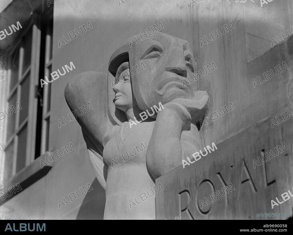 London ' s latest architecture . Mr Alan Durst ' s latest work in two carved Portland stone figures over the doorway of the R A of Dramatic Art in Gower Street . Comedy. 12 November 1931.