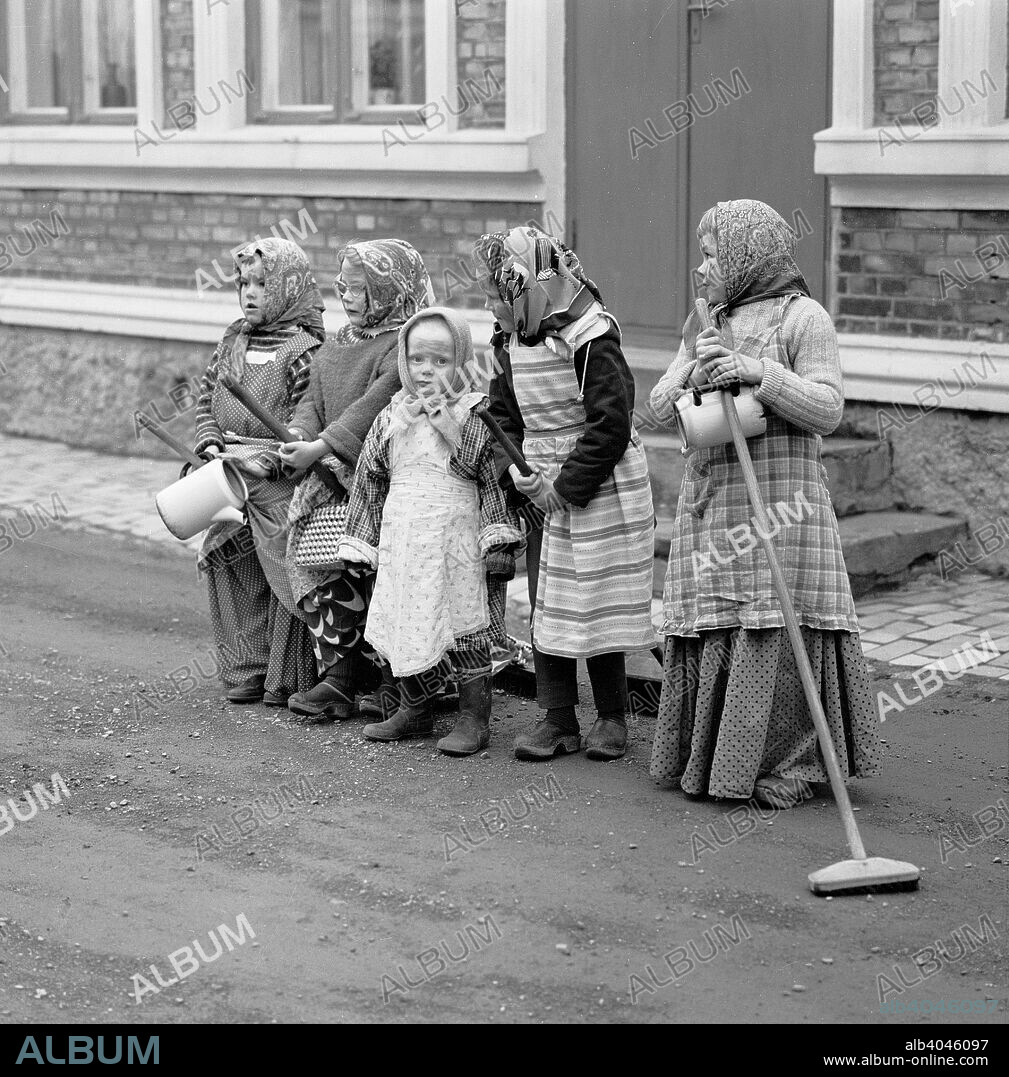 A group of little girls dressed like Easter witches, Landskrona, Sweden, 1963. It is a tradition at Easter in Scandinavia for children to dress up as witches and go door to door asking for sweets, in exchange for which they give decorated pussy willow branches. From the Landskrona Museum Collection.