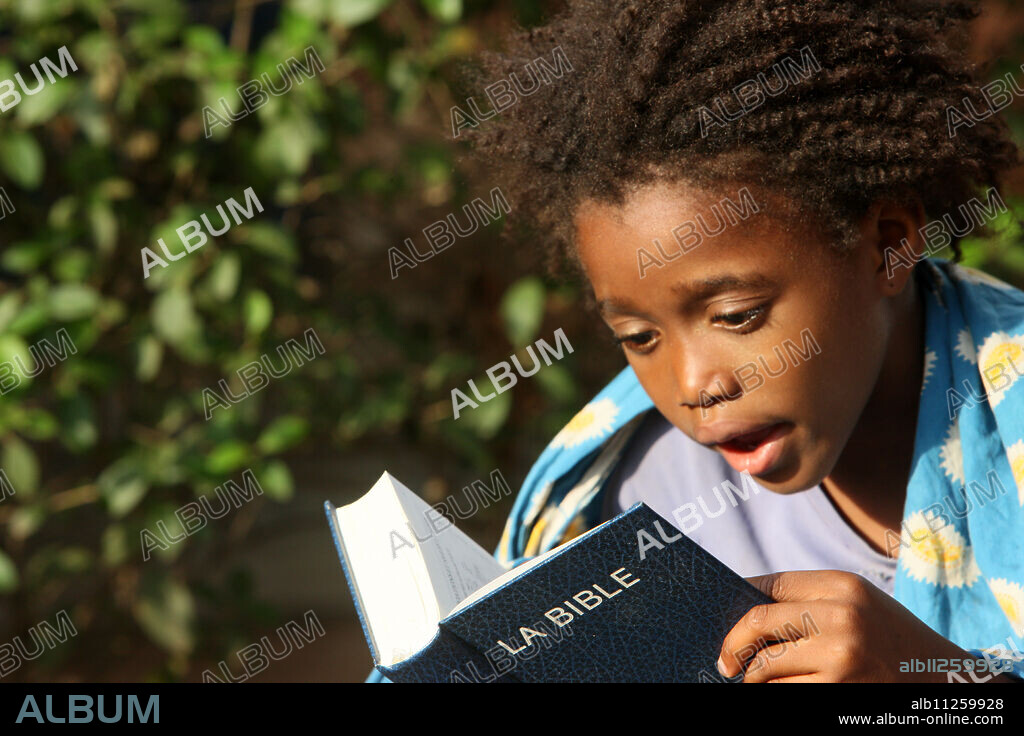 Father and daughter reading the Bible, Lome, Togo, West Africa, Africa.