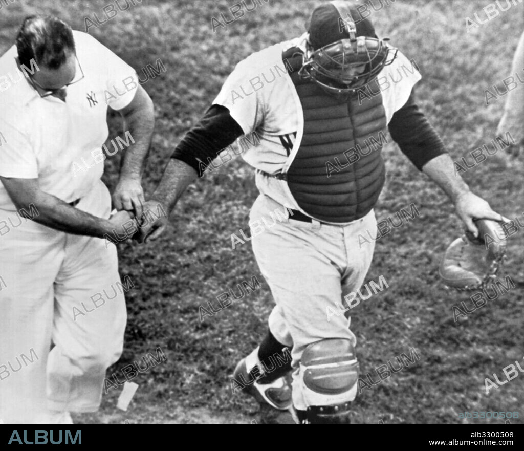 Baltimore, Maryland:  August 24, 1962.New York Yankee catcher Yogi Berra trudges from the field after a foul tip off the bat of Marv Breeding ripped off a finger nail on his right hand.