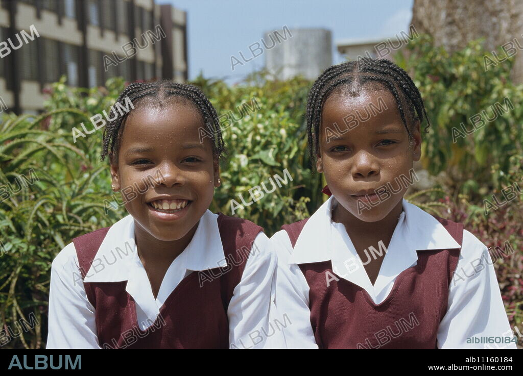 Portrait of two schoolgirls in school uniform, St. John, Barbados, West Indies, Caribbean, Central America.