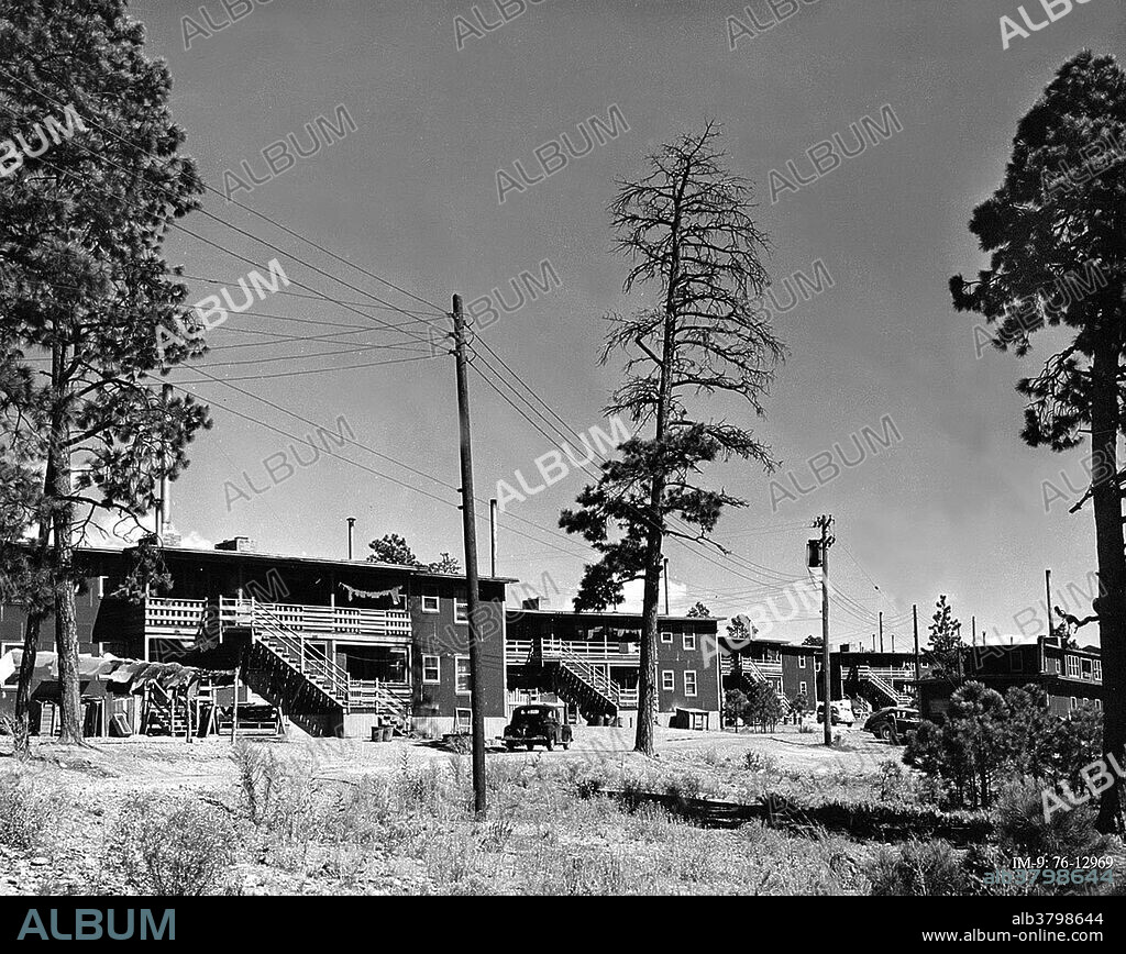 The Sundt Apartments, on Trinity Drive, Los Alamos. These apartments were the homes for some of the greatest physicists in the world during the development of the first atomic bomb. By Los Alamos standards, these homes were luxurious.Throughout the summer of 1943, hundreds of bewildered families moved to Los Alamos to begin an unforgettable adventure. Scientific personnel had only a very general idea about the nature of the work that awaited them. They were instructed to tell their families nothing. Most administrative and technical personnel knew only that they were moving to an unknown place for an unknown length of time. Most lived in trailers and huts put up by the Army in a very short time to try to deal with the massive influx of personnel. Because it was secret, Los Alamos was referred to as "Site Y" or "the Hill". Birth certificates of babies born in Los Alamos during the war listed their place of birth as PO Box 1663 in Santa Fe.