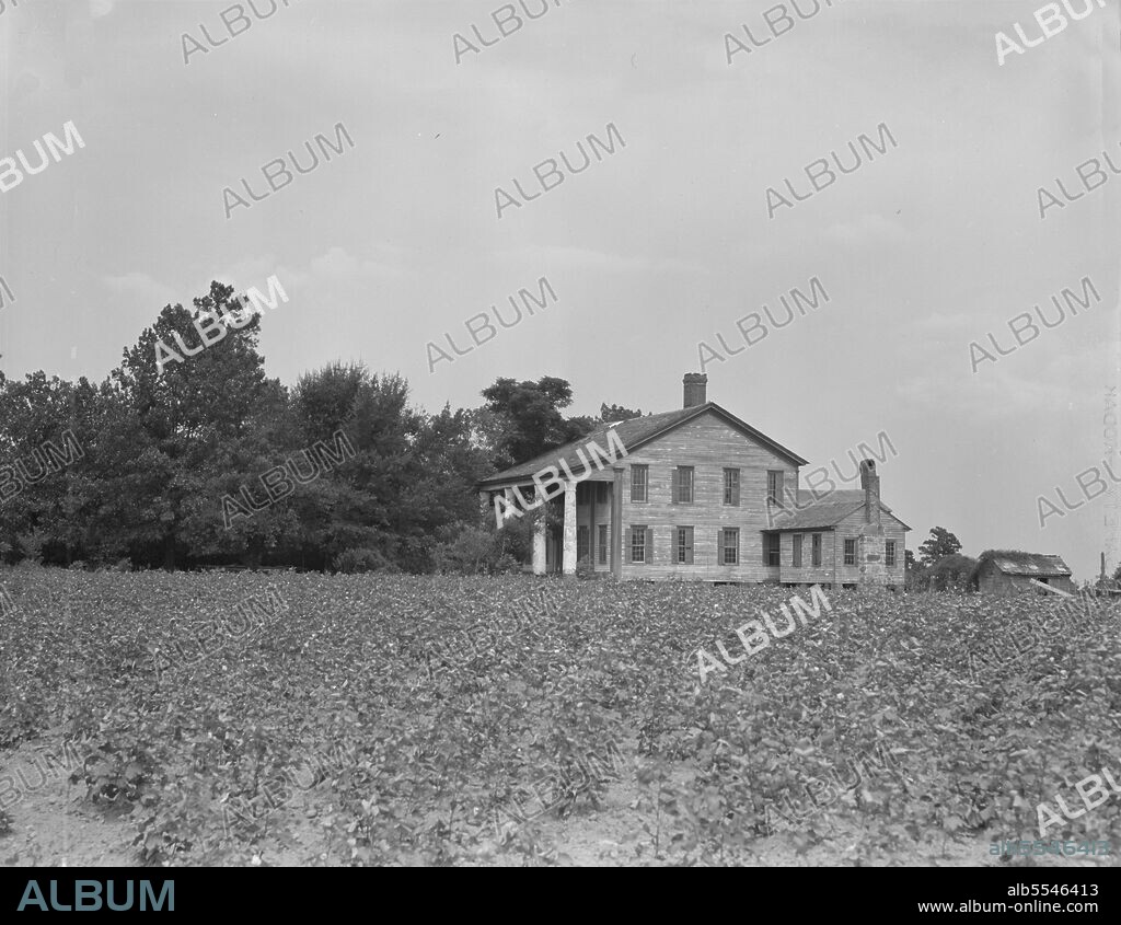 DOROTHEA LANGE. Pharr Plantation house near Social Circle, Georgia. This house was built in 1840 by slave labor. The bricks came from England to Savannah, thence by oxteam to the plantation. The plantation formerly had 150 slaves, is now abandoned by the one remaining member of the family, and the land rented out to small farmers.
