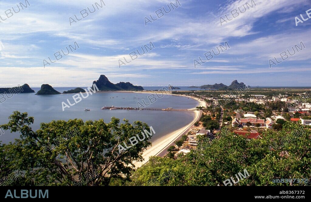 Thailand: Ao Prachuap (Prachuap Bay) seen from Khao Chong Krajok (Mirror Mountain), Prachuap Khiri Khan. In historical terms, Prachuap is significant as one of the seven landing points where Imperial Japanese troops stormed ashore in 1941, on their way south to occupy Malaya and Singapore. The town is ringed on the land side with rugged limestone mountains, one of which is Khao Chong Krajok, or mirror tunnel mountain. Perched atop the hill is a temple called Wat Thammikaram which serves as Prachuaps most revered site.